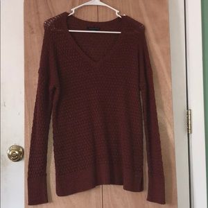 a orange red-ish colored sweater